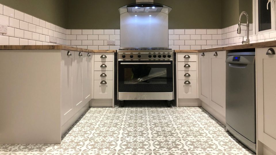 New kitchen fitted with white kitchen cabinets, oven and white tiling at a residential property in Portsmouth